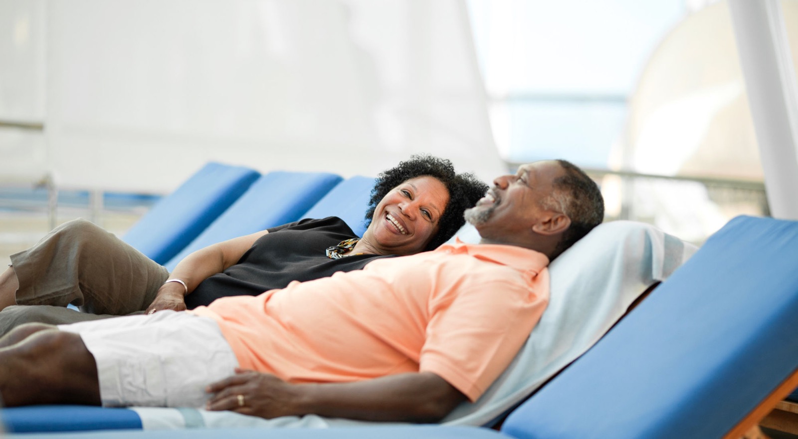 Happy property owners relaxing poolside while OneSource manages their Tallahassee rental